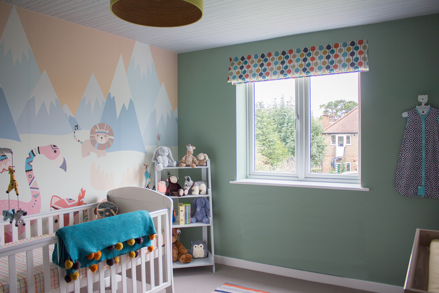 A photo of the new nursery with wallpaper mural