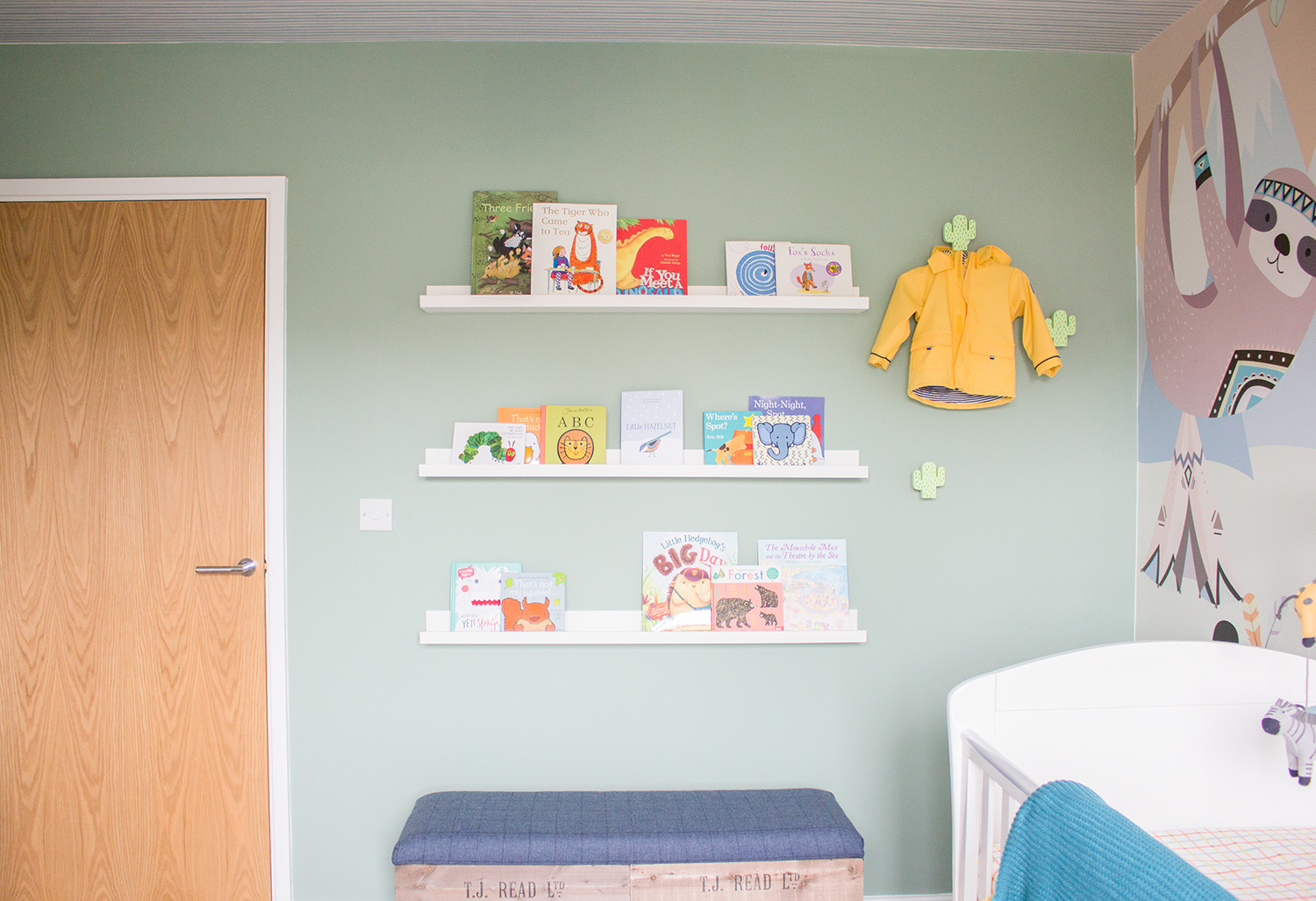 A photo of the new nursery with rows of colourful books on picture shelves.