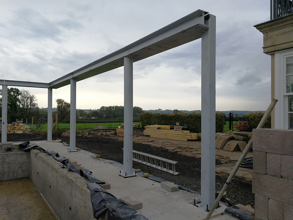 A photo of the structure which will hold up the pool roof.
