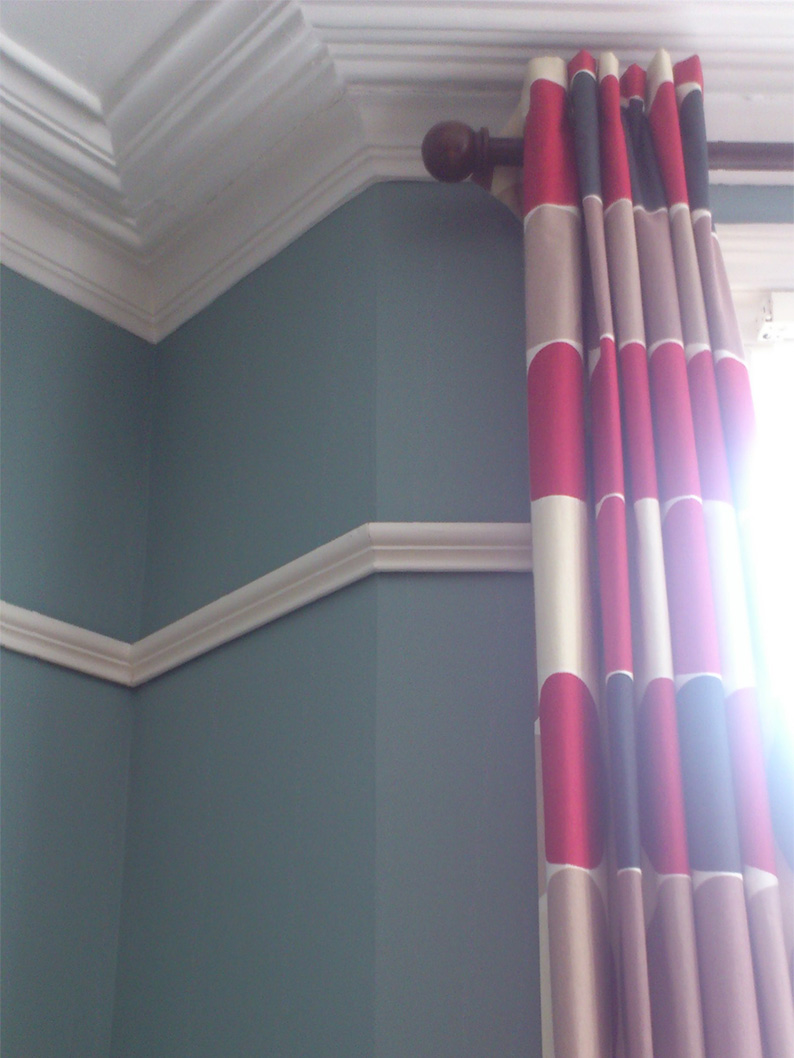 a photo of the temporary living room curtains with the walls painted Oval Room Blue
