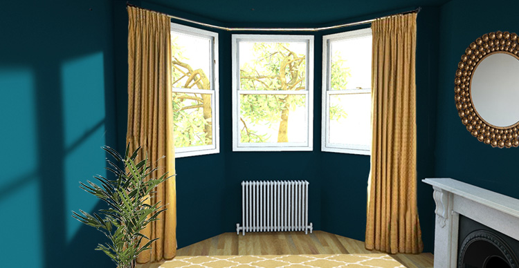 A picture of a bay window with a pair of floor length curtains