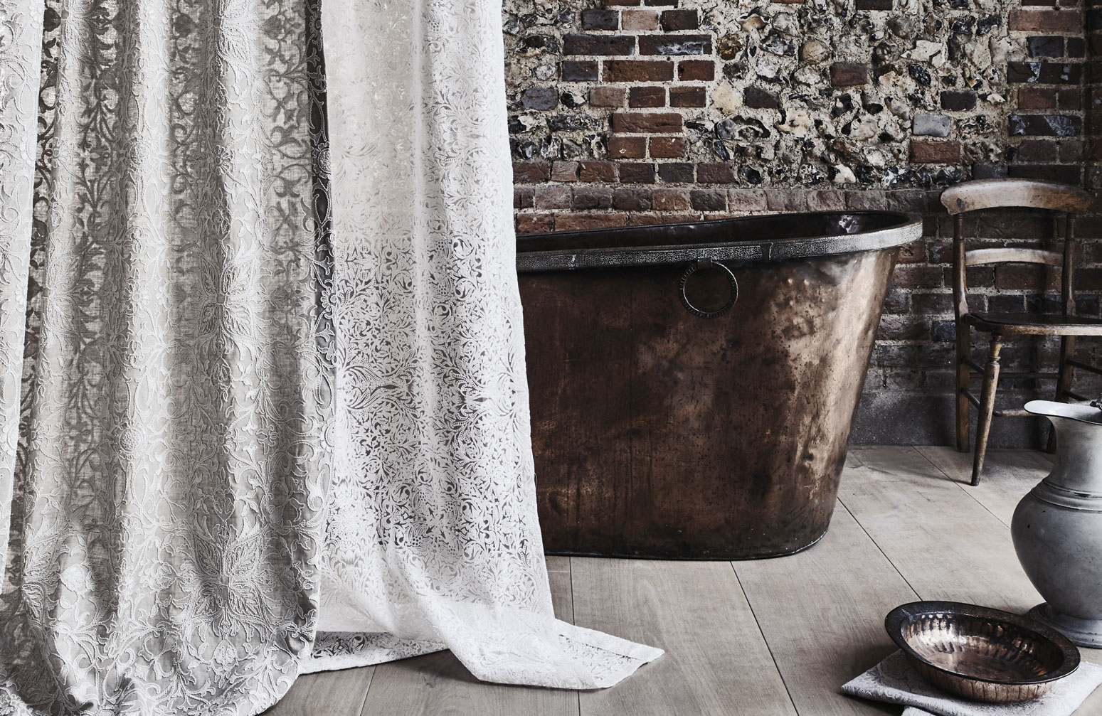 a sheer curtain fabric from the Pure Collection, hanging in front of a copper bath