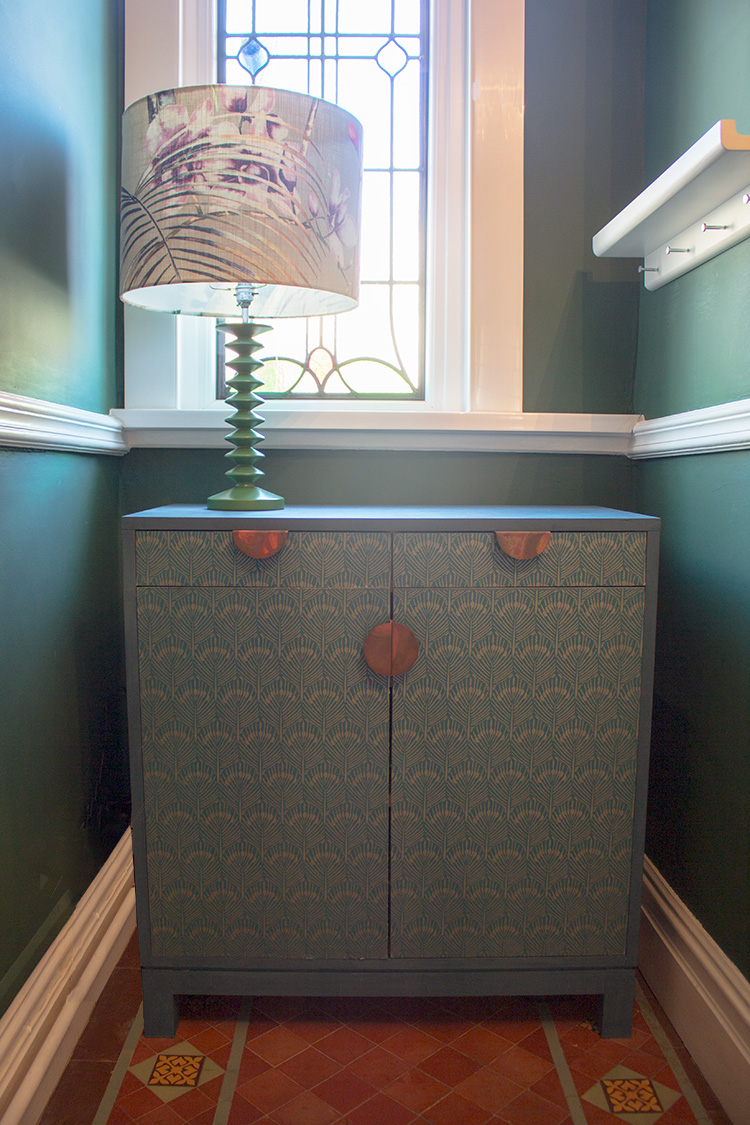A photo of my painted and wallpapered hallway cupboard.