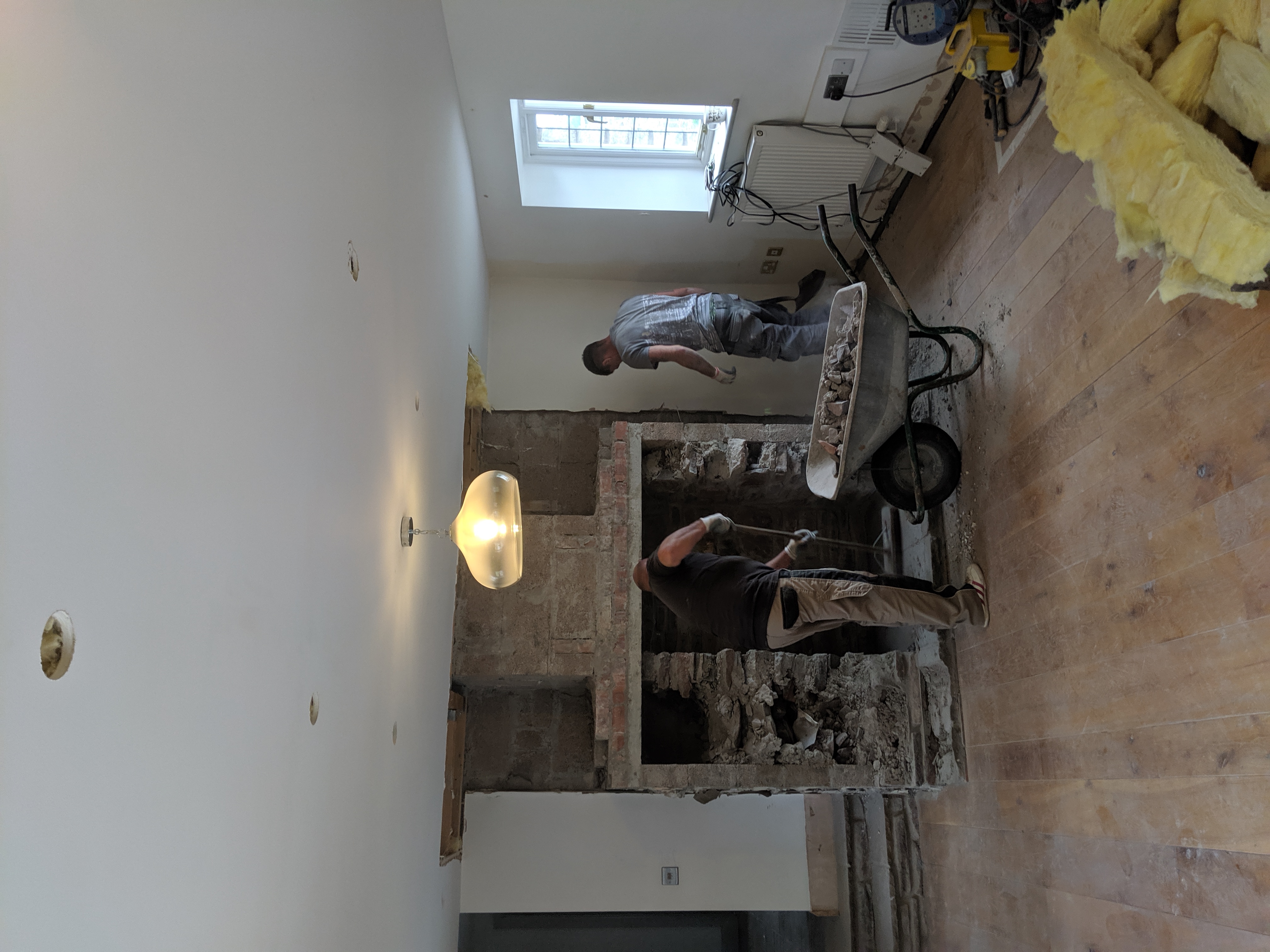 A photo of the chimney breast being taken out.