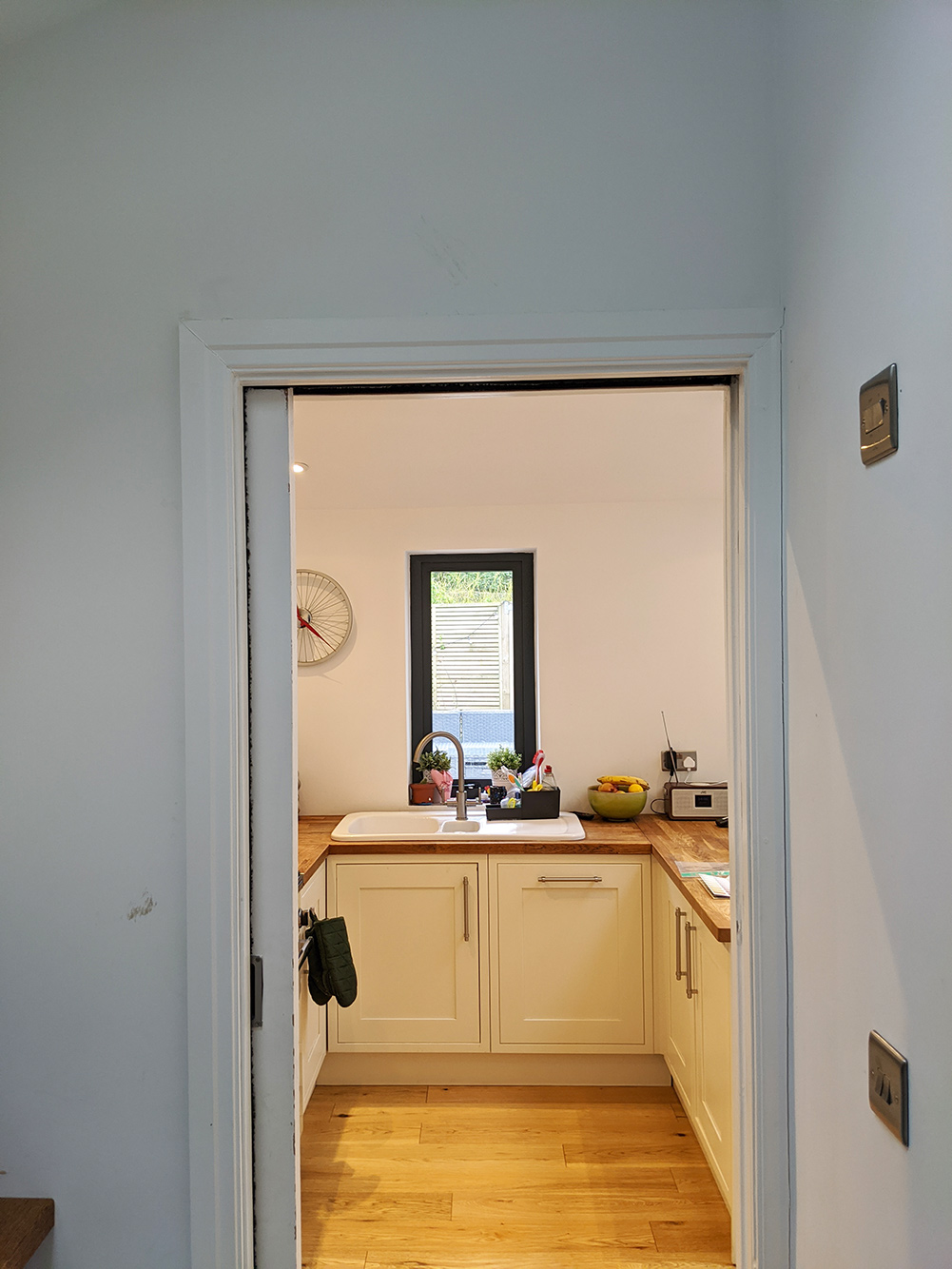 A photo showing the view from the pantry to the kitchen